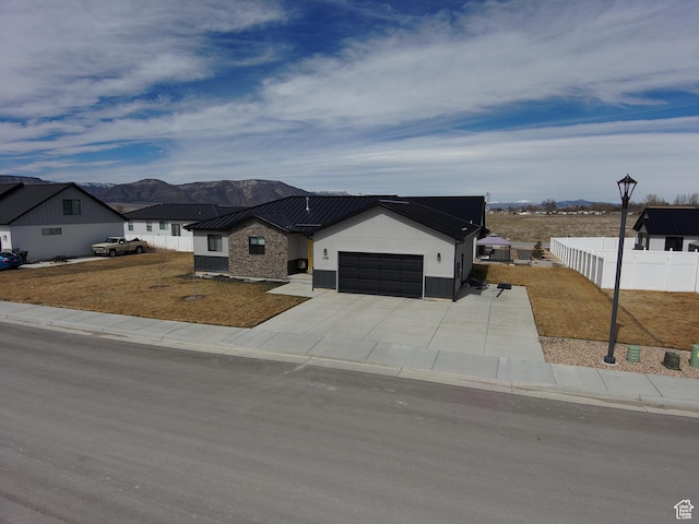 306 W 450 S, Ephraim, UT 84627 - modern farmhouse style home featuring an attached garage, a standing seam roof, a mountain view, a metal roof, and concrete driveway
