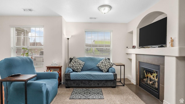 sitting room featuring visible vents, a fireplace, and tile patterned flooring