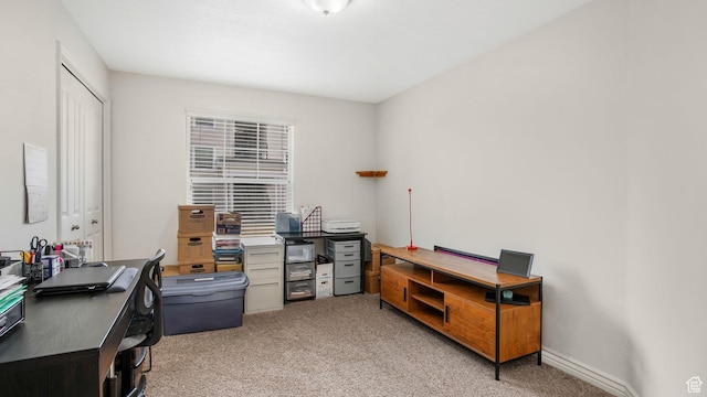 office with light carpet and baseboards
