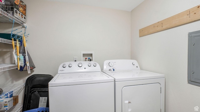 laundry room with laundry area, electric panel, and washing machine and clothes dryer