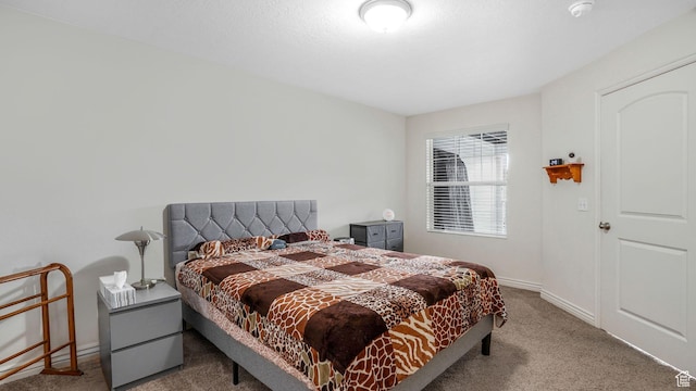 carpeted bedroom featuring baseboards
