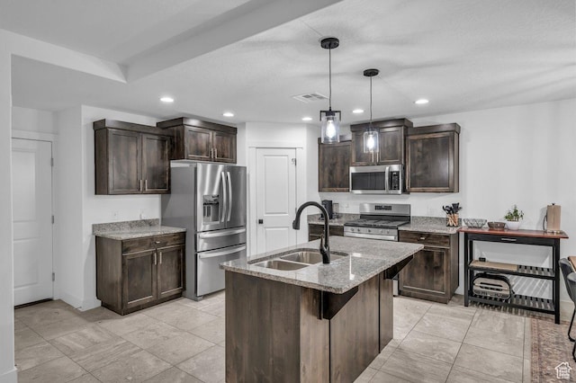 3231 S 300 W, Washington, UT 84780 - kitchen with visible vents, a sink, dark brown cabinets, stainless steel appliances, and light stone counters