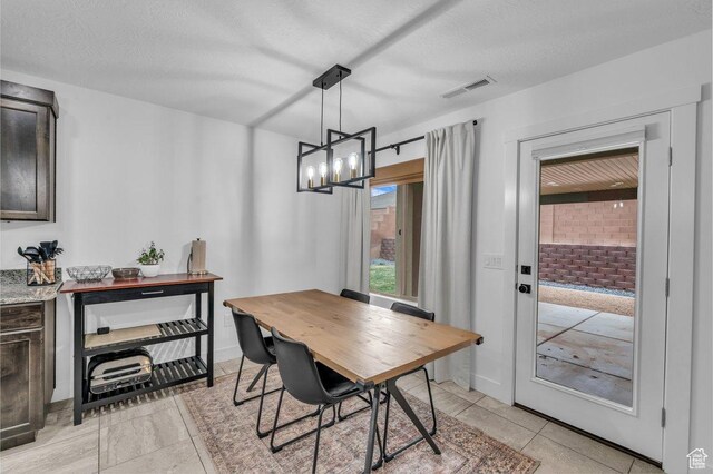 3231 S 300 W, Washington, UT 84780 - dining room with light tile patterned floors, visible vents, a textured ceiling, and an inviting chandelier