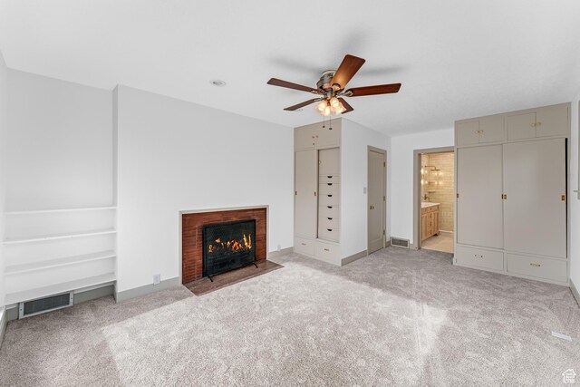 130 E 200 S, Provo, UT 84606 - unfurnished living room featuring visible vents, a brick fireplace, baseboards, ceiling fan, and light carpet