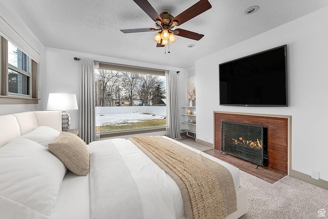 130 E 200 S, Provo, UT 84606 - bedroom with multiple windows, a textured ceiling, and a fireplace with flush hearth