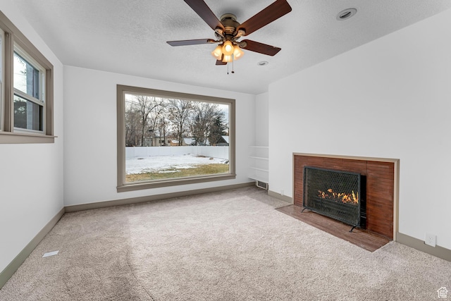 130 E 200 S, Provo, UT 84606 - unfurnished living room with a fireplace with flush hearth, a textured ceiling, carpet floors, baseboards, and ceiling fan