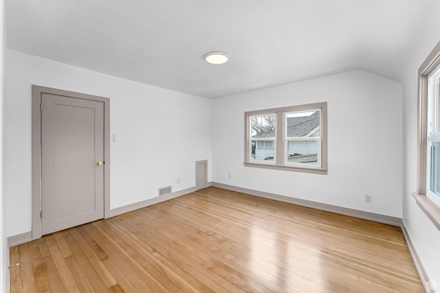 130 E 200 S, Provo, UT 84606 - empty room featuring vaulted ceiling, light wood-style flooring, baseboards, and visible vents