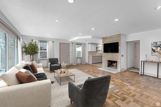 130 E 200 S, Provo, UT 84606 - living area featuring recessed lighting, a fireplace, a textured ceiling, and baseboards