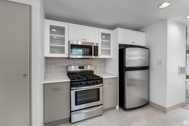 130 E 200 S, Provo, UT 84606 - kitchen featuring stainless steel appliances, tasteful backsplash, visible vents, and light countertops