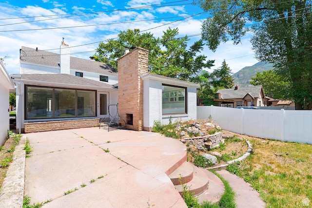 130 E 200 S, Provo, UT 84606 - back of property with a patio area, a mountain view, and a chimney