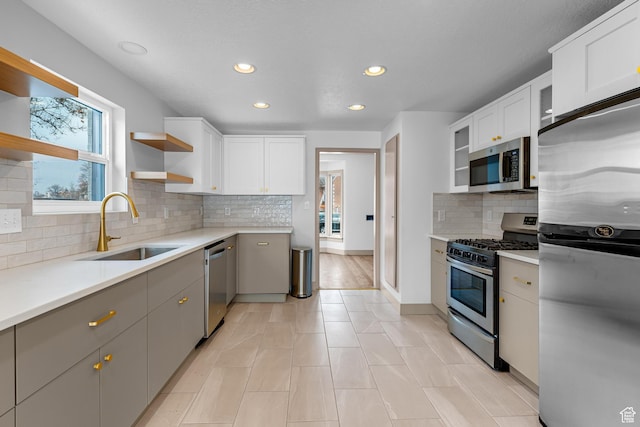 130 E 200 S, Provo, UT 84606 - kitchen featuring a sink, stainless steel appliances, open shelves, and white cabinetry