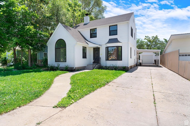 130 E 200 S, Provo, UT 84606 - view of front of house featuring a chimney, concrete driveway, an outdoor structure, and a shingled roof