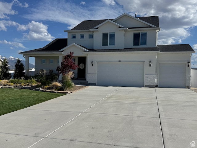 134 E Marciano Way, Grantsville, UT 84029 - view of front of home with concrete driveway, stucco siding, an attached garage, and a front lawn