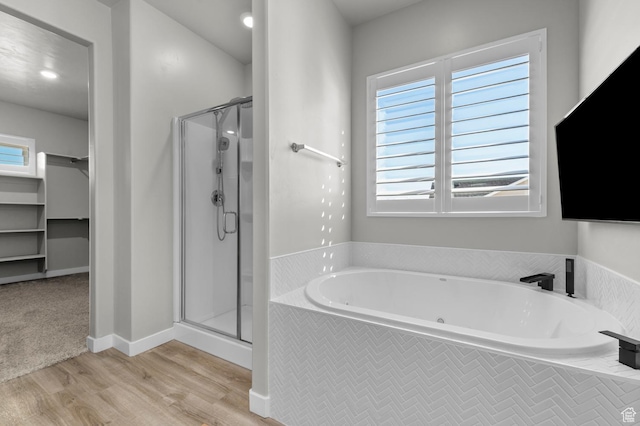 134 E Marciano Way, Grantsville, UT 84029 - bathroom with a bath, wood finished floors, and a stall shower