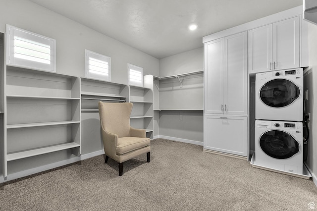 134 E Marciano Way, Grantsville, UT 84029 - laundry room featuring stacked washer and clothes dryer, cabinet space, light carpet, and baseboards