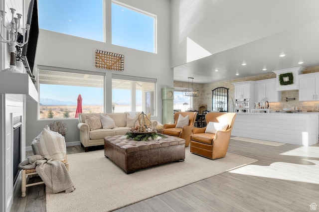 134 E Marciano Way, Grantsville, UT 84029 - living room featuring recessed lighting, a high ceiling, plenty of natural light, and wood finished floors