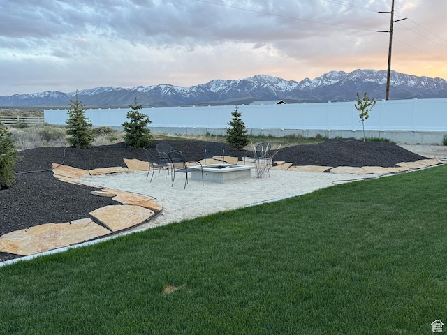 134 E Marciano Way, Grantsville, UT 84029 - view of yard featuring an outdoor fire pit, a patio, a mountain view, and a fenced backyard