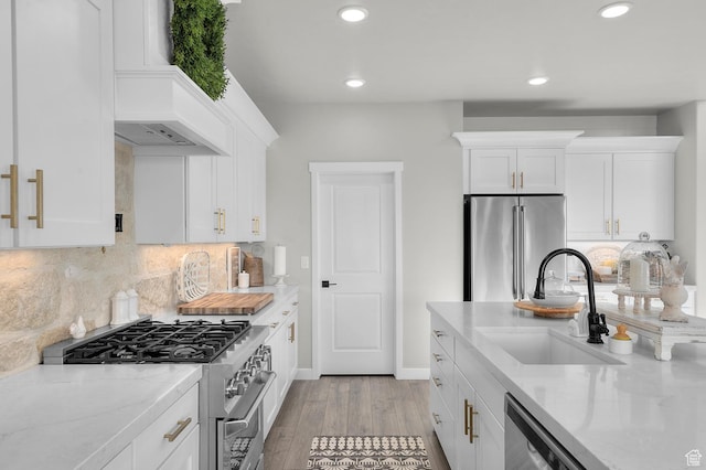 134 E Marciano Way, Grantsville, UT 84029 - kitchen with a sink, appliances with stainless steel finishes, white cabinets, light stone countertops, and light wood-style floors