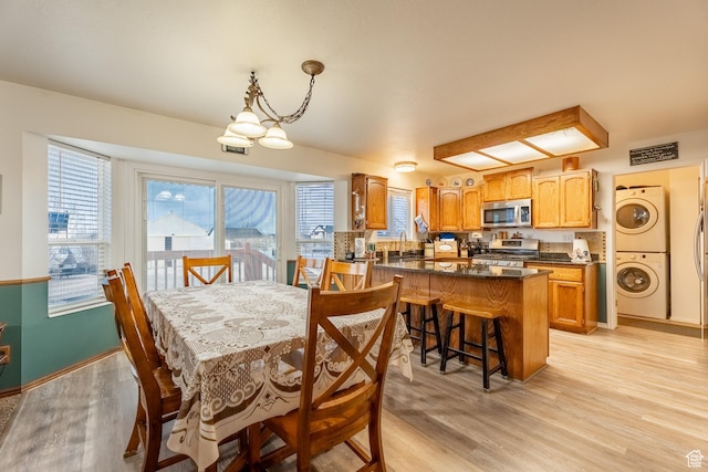 2602 W 1800 S, West Haven, UT 84401 - dining area with stacked washing maching and dryer and light wood-style floors