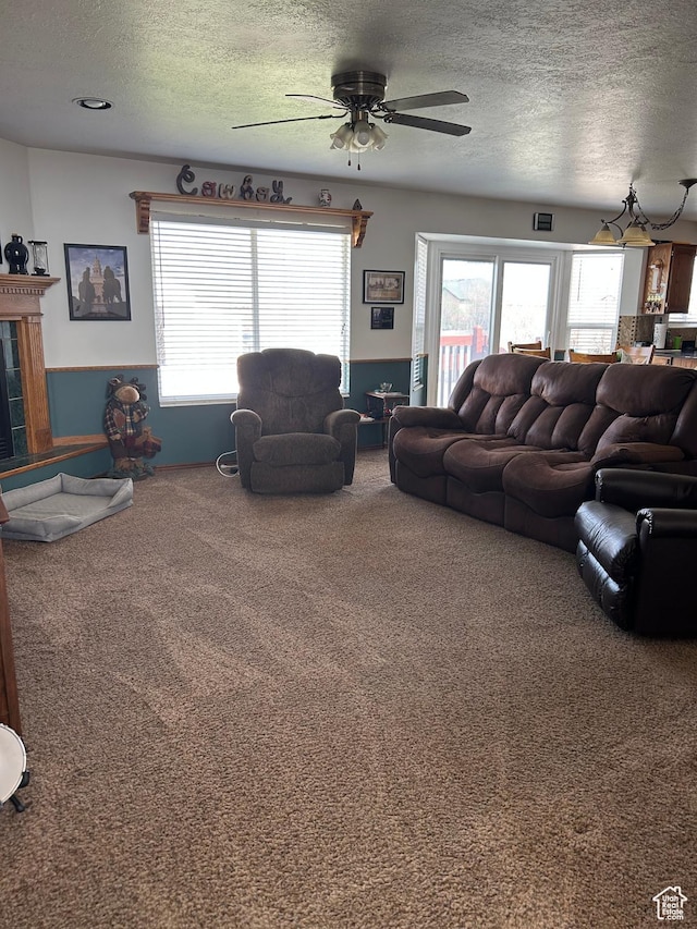 2602 W 1800 S, West Haven, UT 84401 - living area featuring ceiling fan, a textured ceiling, carpet, and a healthy amount of sunlight