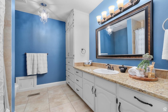 bathroom featuring tile patterned flooring, visible vents, vanity, and an inviting chandelier