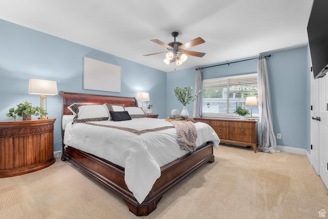 bedroom featuring baseboards, a ceiling fan, and carpet flooring