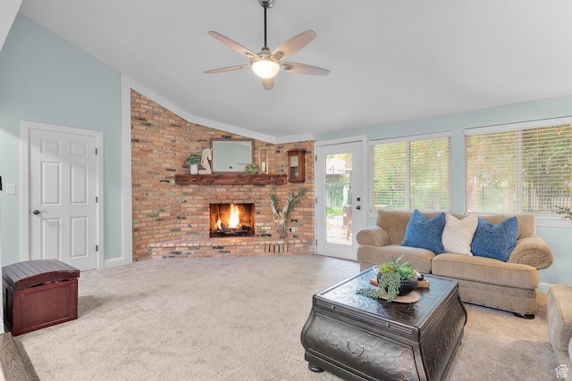carpeted living area with a fireplace, lofted ceiling, a ceiling fan, and brick wall