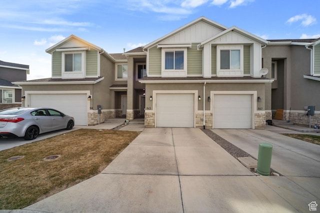 843 N Gleneagles Ct, Tooele, UT 84074 - view of front of house featuring a garage, stone siding, driveway, and stucco siding