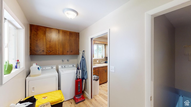 1207 S 600 W, Preston, ID 83263 - laundry area featuring cabinet space, washing machine and dryer, and light wood-style flooring