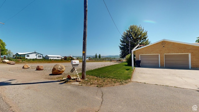 1207 S 600 W, Preston, ID 83263 - view of yard with a garage and driveway
