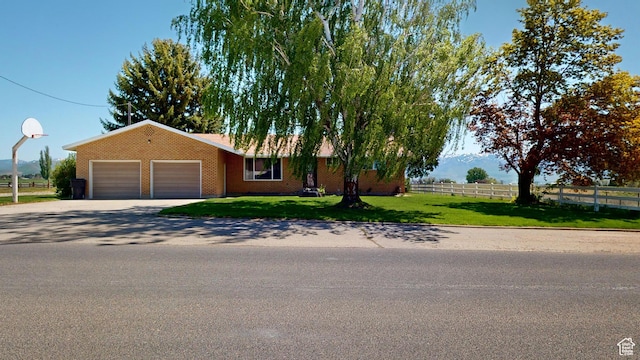 1207 S 600 W, Preston, ID 83263 - view of front of house featuring a garage, concrete driveway, and brick siding