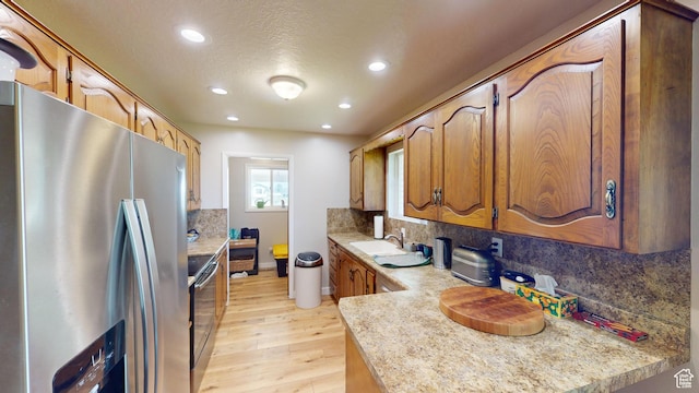 1207 S 600 W, Preston, ID 83263 - kitchen with stainless steel appliances, light wood-style floors, light countertops, recessed lighting, and tasteful backsplash