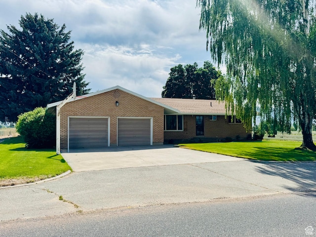 1207 S 600 W, Preston, ID 83263 - ranch-style home with a garage, driveway, a front yard, and brick siding