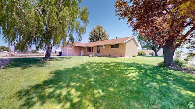 1207 S 600 W, Preston, ID 83263 - view of front of house with a front lawn, brick siding, and a garage