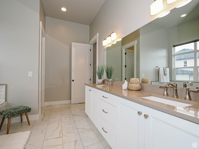 bathroom featuring recessed lighting, baseboards, marble finish floor, and a sink