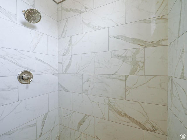 full bath with a tile shower