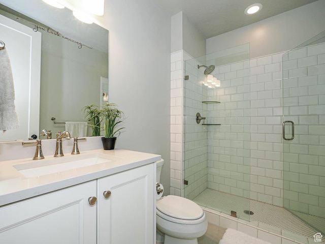 full bathroom with a shower stall, toilet, and vanity