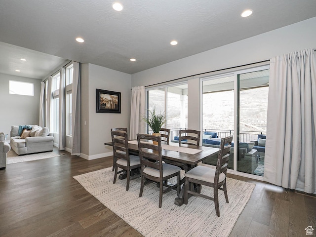 dining room with recessed lighting, baseboards, dark wood-type flooring, and a textured ceiling