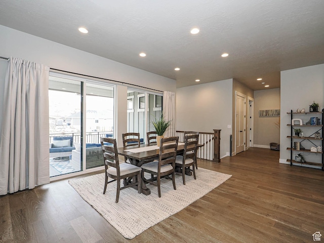 dining room featuring recessed lighting, wood finished floors, baseboards, and a textured ceiling