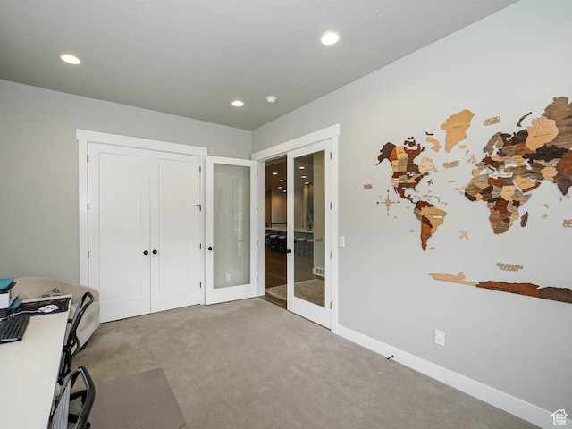 carpeted office space with recessed lighting, french doors, and baseboards