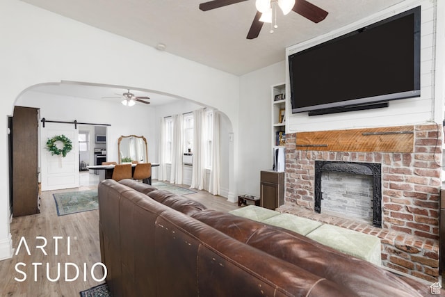2516 S Orchard Ave, Ogden, UT 84401 - living area featuring a brick fireplace, arched walkways, and ceiling fan