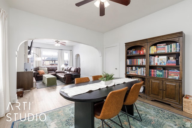2516 S Orchard Ave, Ogden, UT 84401 - dining room featuring arched walkways, wood finished floors, and a ceiling fan