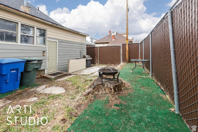 2516 S Orchard Ave, Ogden, UT 84401 - view of yard with a fenced backyard and an outdoor fire pit
