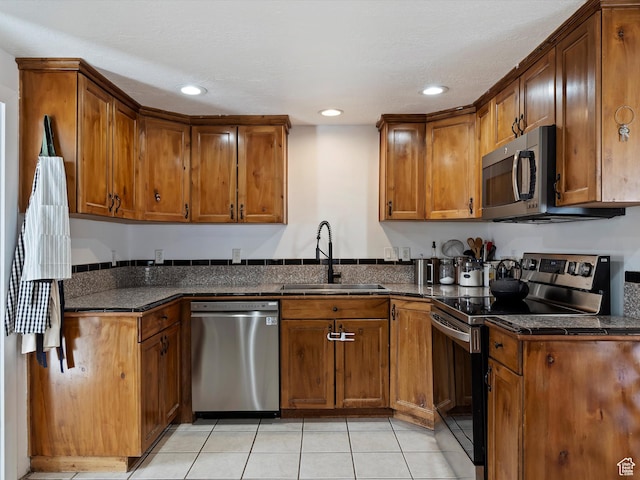 3911 W 2250 N, Corinne, UT 84307 - kitchen featuring a sink, appliances with stainless steel finishes, and brown cabinetry
