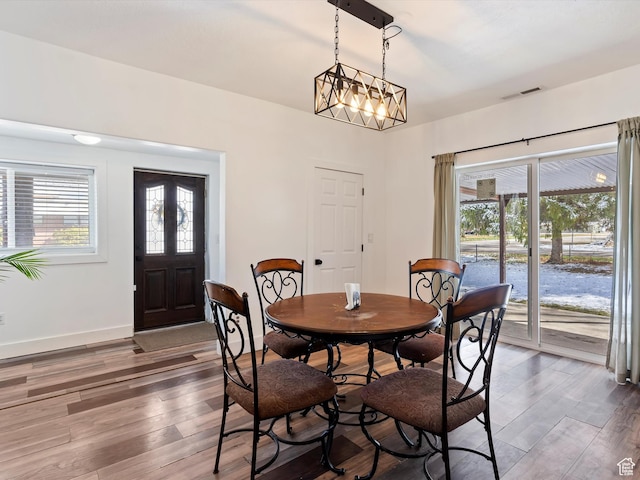 3911 W 2250 N, Corinne, UT 84307 - dining room featuring visible vents, baseboards, wood finished floors, and a chandelier