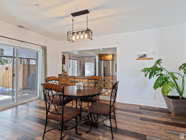 3911 W 2250 N, Corinne, UT 84307 - dining room with a healthy amount of sunlight, visible vents, and dark wood-style flooring