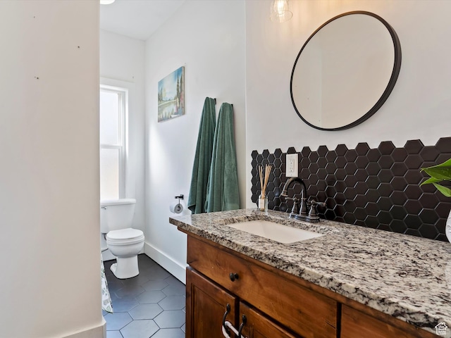 3911 W 2250 N, Corinne, UT 84307 - bathroom featuring vanity, baseboards, tile patterned flooring, toilet, and backsplash