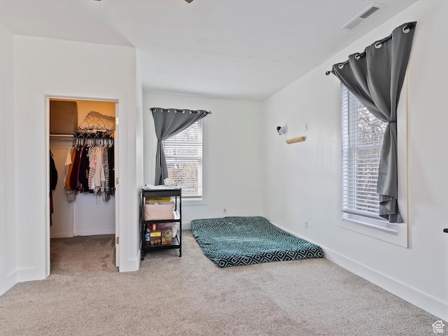 3911 W 2250 N, Corinne, UT 84307 - carpeted bedroom featuring a closet, visible vents, a walk in closet, and baseboards