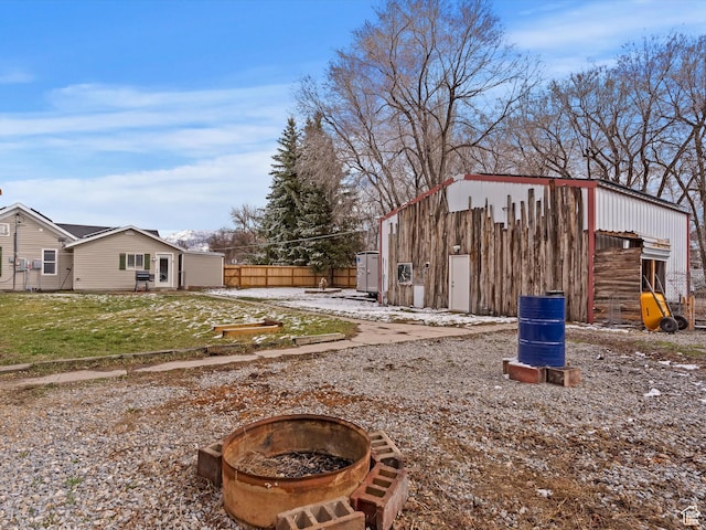 3911 W 2250 N, Corinne, UT 84307 - view of yard featuring an outbuilding, fence, and an outdoor fire pit