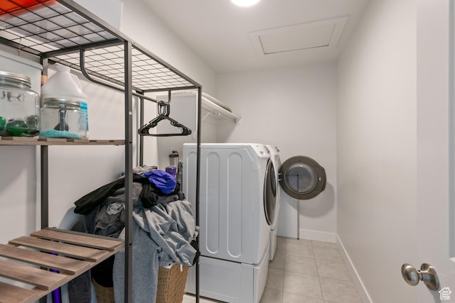 laundry area featuring tile patterned flooring, baseboards, washing machine and dryer, attic access, and laundry area